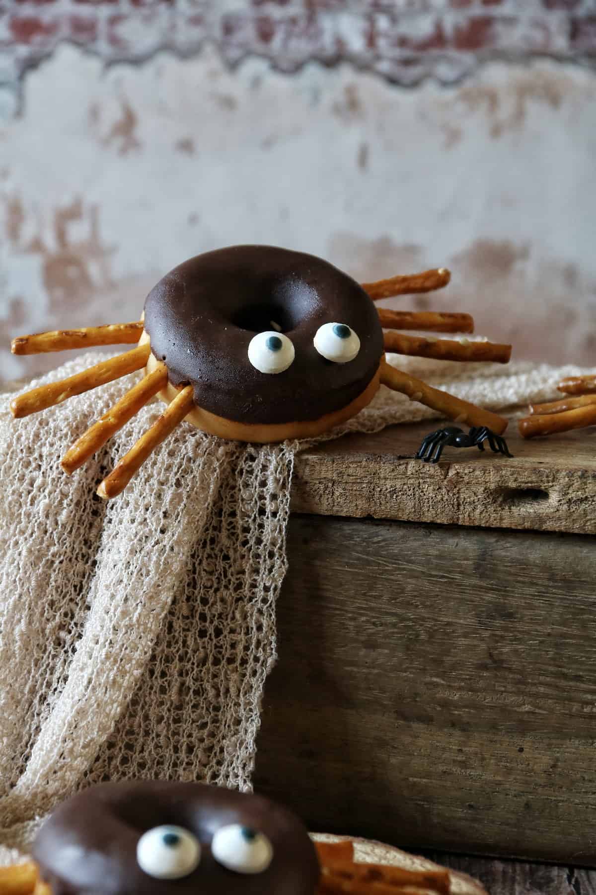 Spinnen-Donut zu Halloween auf einer Holzkiste